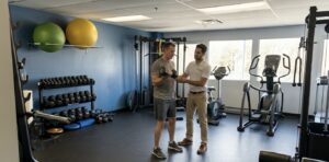Physiotherapist helping patient with exercises.