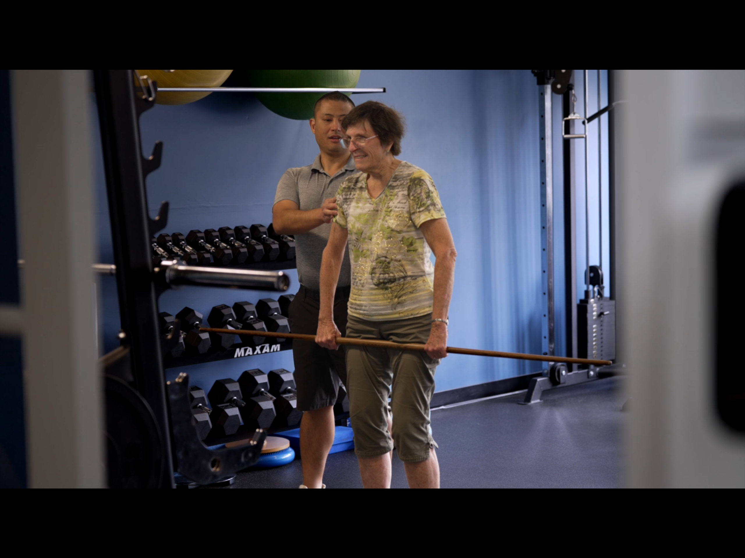 Physiotherapist assisting a patient with an exercise.