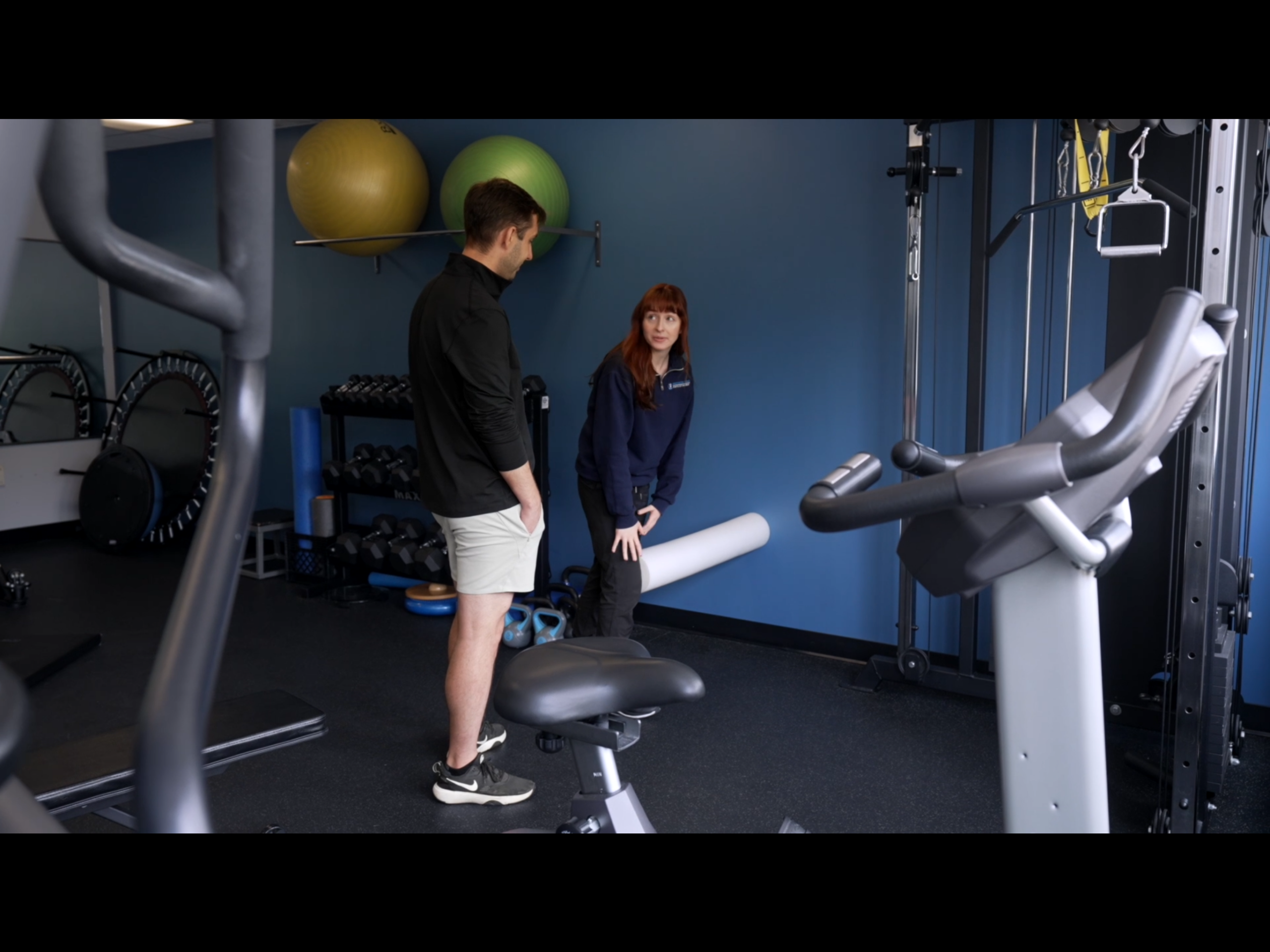 A physiotherapist helping a patient with their exerices.