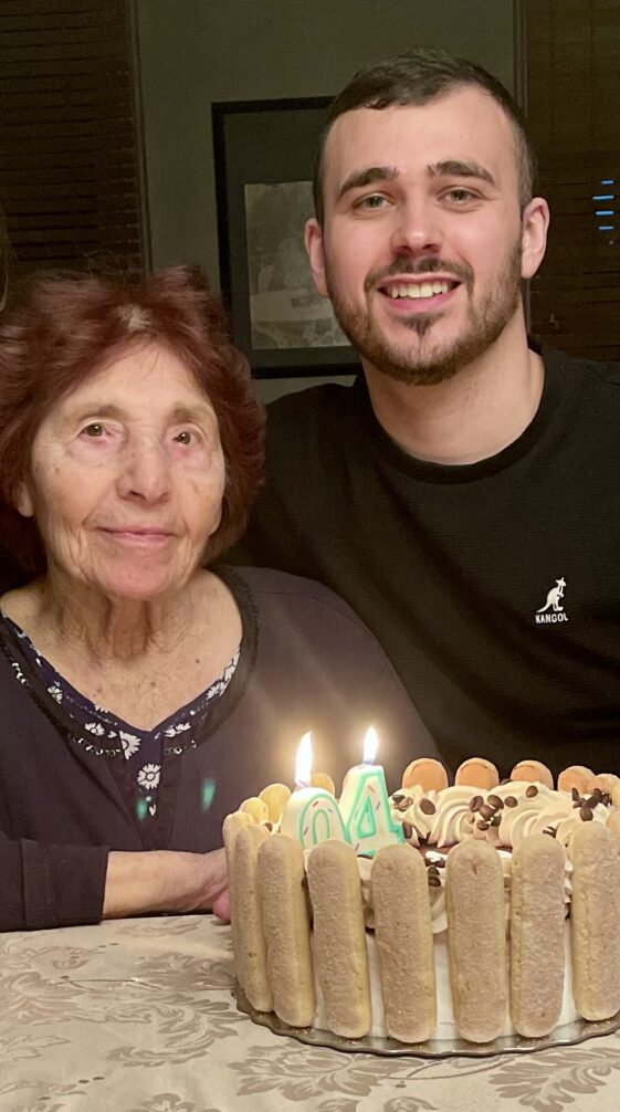 Boy with his grandmother on her birthday with a birthday cake.