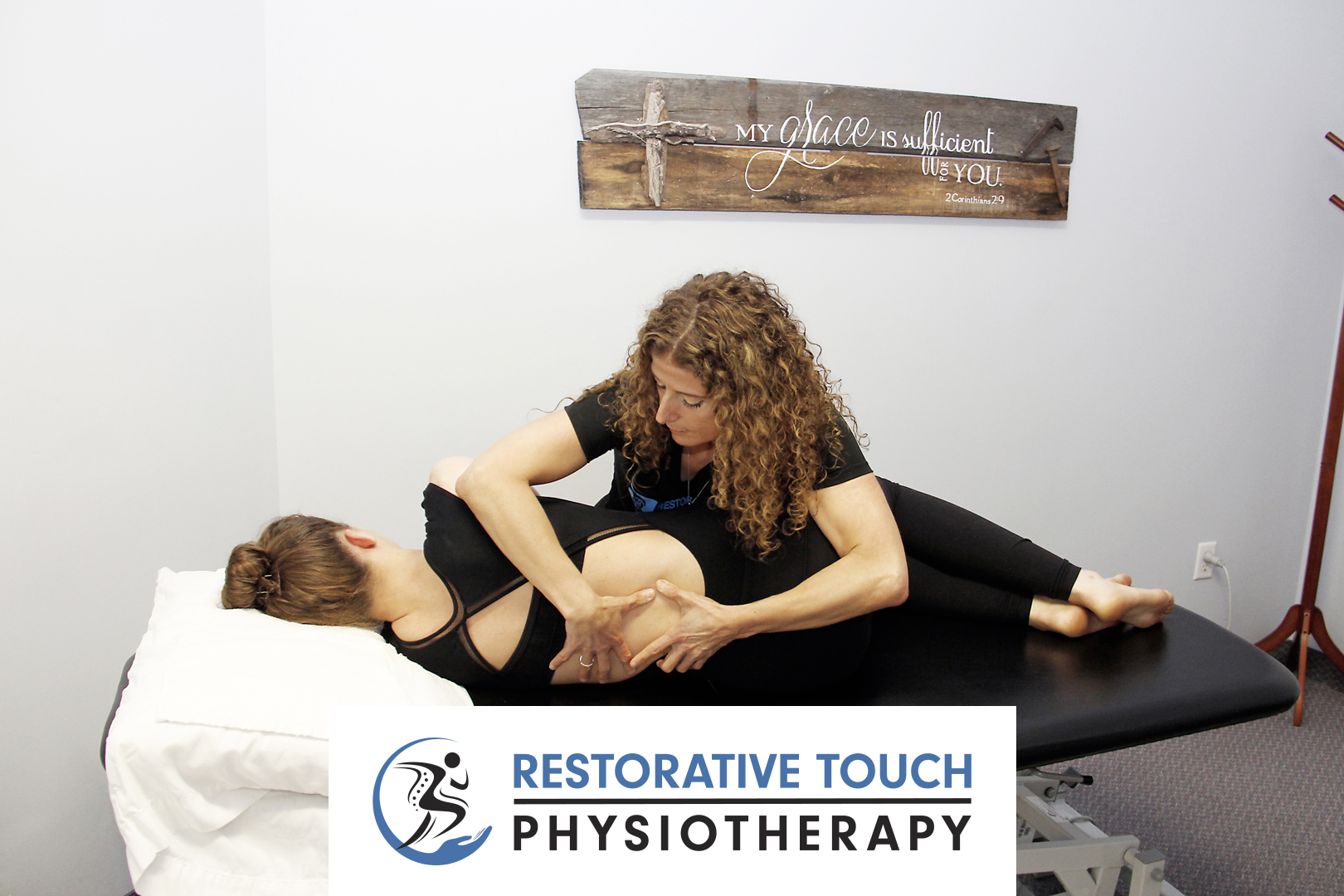 Hamilton Mountain Physiotherapy Clinic, Restorative Touch owner Marilena working on a patient's back while they are lying on their side on a table with the Restorative Touch Physiotherapy logo in the bottom center